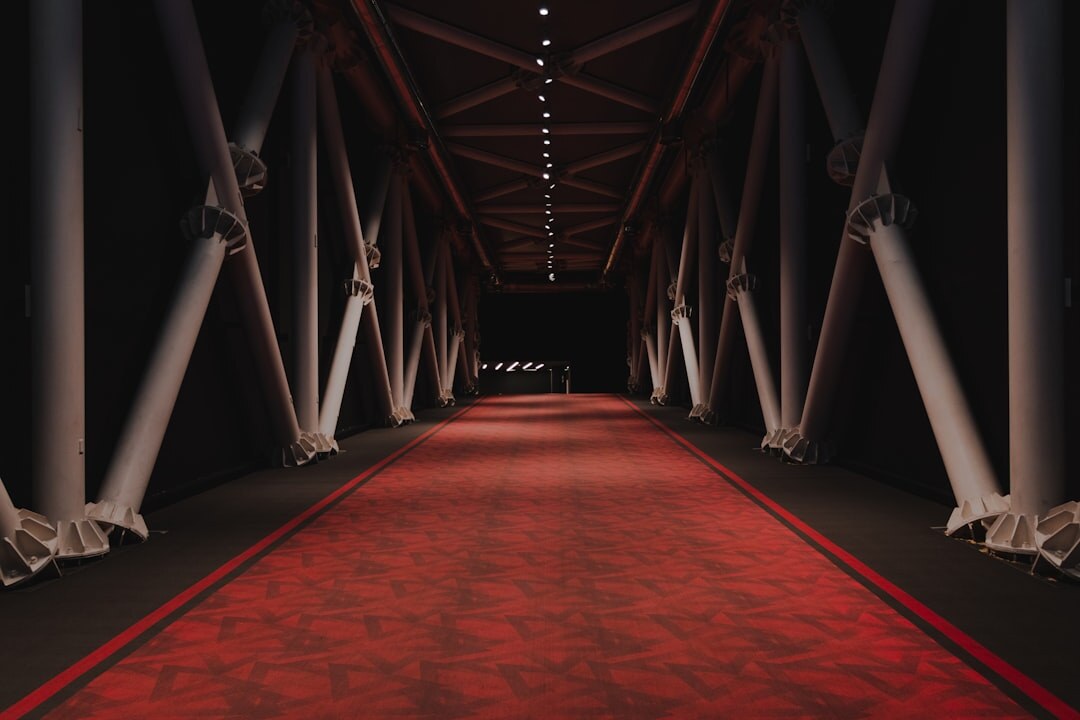 Celebrities walking on a red carpet at an evening awards event