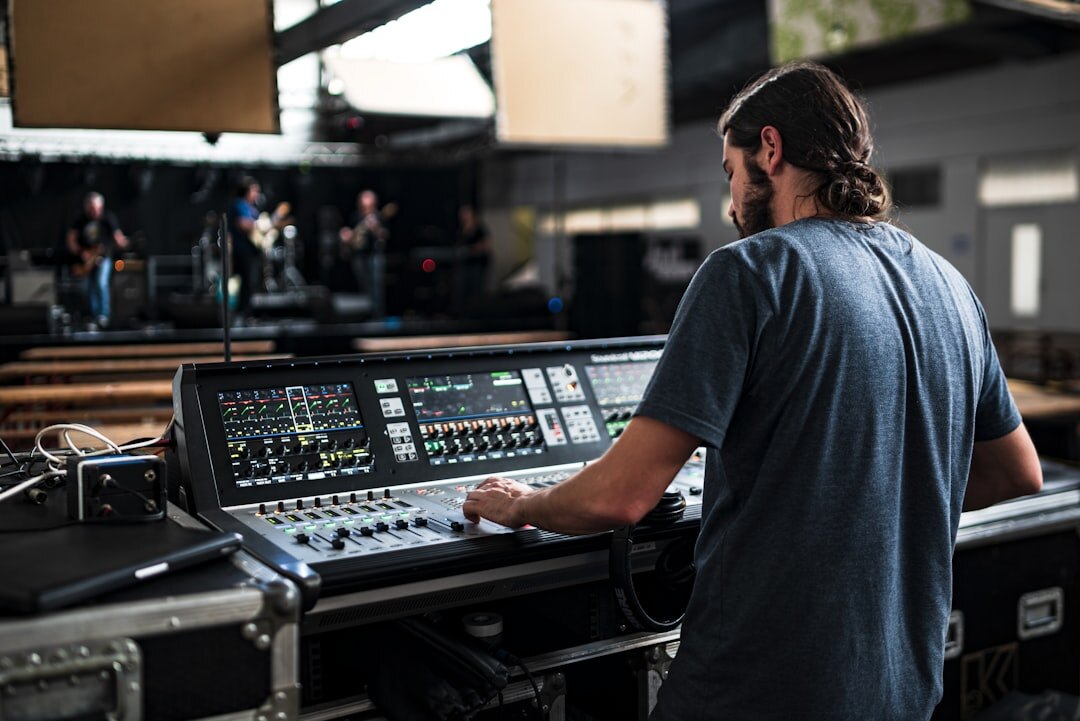 Sound engineer adjusting equipment before a live music show