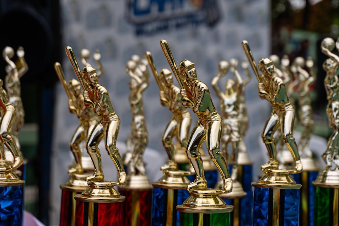 Golden trophy statuettes displayed before an awards ceremony